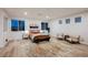 Spacious main bedroom with many windows, light wood floors, and contemporary furnishings at 800 Loch Katrine Ave, Henderson, NV 89012