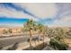 Street view with palm trees and other greenery in the foreground and houses in the background at 800 Loch Katrine Ave, Henderson, NV 89012