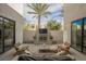 Inviting outdoor patio featuring a fireplace, mounted television, comfortable seating, and a well manicured landscape at 800 Loch Katrine Ave, Henderson, NV 89012