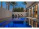 Backyard pool and spa illuminated at night, complemented by stylish lighting and modern architecture at 800 Loch Katrine Ave, Henderson, NV 89012