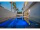 Dusk view of backyard pool and spa with stylish lighting, set against a modern home with sleek design at 800 Loch Katrine Ave, Henderson, NV 89012