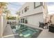 An inviting backyard with a modern pool, ample seating, and outdoor cooking area ideal for leisure and entertainment at 800 Loch Katrine Ave, Henderson, NV 89012