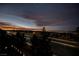 Dusk view of a street with several houses and orange and purple skies in the background at 800 Loch Katrine Ave, Henderson, NV 89012