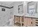 Modern bathroom showcasing double sinks with wood cabinets and decorative tile accents at 808 N Torrey Pines Dr, Las Vegas, NV 89107