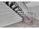 Carpeted staircase with modern black metal handrail at 808 N Torrey Pines Dr, Las Vegas, NV 89107