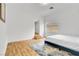 Serene bedroom with wood floors, blue accent rug, and bright natural light at 8720 Castle View Ave, Las Vegas, NV 89129