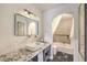 Bright bathroom with a sleek vanity, and a tub featuring decorative tile at 8969 Clairton Ct, Las Vegas, NV 89117