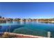 Scenic waterfront view featuring stunning homes and clear blue waters, reflecting the sky at 8969 Clairton Ct, Las Vegas, NV 89117