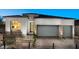 Attractive single-story home featuring a three-car garage, modern design, and low-maintenance landscaping at 8988 Indigo Rose St, Las Vegas, NV 89166