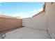 Concrete backyard with a combination of brick and vinyl fencing at 9304 Cranesbill Ct, Las Vegas, NV 89149