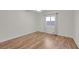 Bedroom with wood flooring, a ceiling fan, and a window with natural light at 9304 Cranesbill Ct, Las Vegas, NV 89149