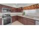 Bright kitchen featuring stainless steel appliances, tile flooring, and modern countertops at 9304 Cranesbill Ct, Las Vegas, NV 89149