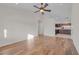 Sunlit living room featuring hardwood floors and an adjacent kitchen at 9304 Cranesbill Ct, Las Vegas, NV 89149