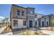 Contemporary townhouse showcasing a two-tone exterior, manicured front yard, and inviting walkway at 9327 Jade Mesa St # 59, Las Vegas, NV 89139