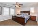 Comfortable bedroom featuring neutral walls, a ceiling fan, and windows with white shutters at 937 Spiracle Ave, Henderson, NV 89002