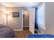 Cozy bedroom featuring neutral walls, a walk-in closet, and a window with bright white shutters at 937 Spiracle Ave, Henderson, NV 89002