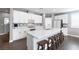 Spacious kitchen featuring an island with barstool seating and modern white cabinets at 937 Spiracle Ave, Henderson, NV 89002