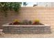 A stone planter with colorful flowers adds a touch of natural beauty to the backyard with decorative gravel at 937 Spiracle Ave, Henderson, NV 89002