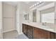 Bathroom featuring double sinks, tile floors, and framed mirrors at 9413 Aggie Ct, Las Vegas, NV 89148