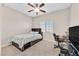 Comfortable bedroom with a window, work desk, and bed with drawers at 9413 Aggie Ct, Las Vegas, NV 89148