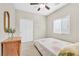 Cozy bedroom with neutral walls, carpet floors, a ceiling fan and a large window with blinds at 9413 Aggie Ct, Las Vegas, NV 89148