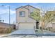 Charming two-story home featuring a tan stucco exterior, two car garage and well-maintained landscaping at 9413 Aggie Ct, Las Vegas, NV 89148