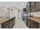Bright kitchen features dark wood cabinets and stainless steel appliances at 9413 Aggie Ct, Las Vegas, NV 89148