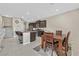 Open concept kitchen with stainless steel appliances flows into the dining area and staircase at 9413 Aggie Ct, Las Vegas, NV 89148