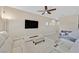 Relaxing living room with large screen television and a white leather sectional at 9413 Aggie Ct, Las Vegas, NV 89148
