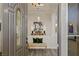 Inviting foyer with a decorative door, light gray flooring, and an eye-catching entryway bench at 9421 Queen Charlotte Dr, Las Vegas, NV 89145