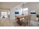 Elegant dining room featuring a wood table, seating for six, and artwork adorning the walls at 9882 Pioneer Ave, Las Vegas, NV 89117