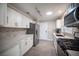 Updated kitchen featuring white cabinetry, stainless steel appliances, and modern countertops at 10121 Hemet Dr, Las Vegas, NV 89134