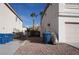 View of the side yard between two homes featuring desert landscaping and tall palm trees at 10228 W Crepe Myrtle Ct, Las Vegas, NV 89183