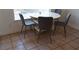 Dining area featuring a white table with four gray chairs at 10228 W Crepe Myrtle Ct, Las Vegas, NV 89183