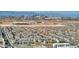 Expansive aerial view showcases a large neighborhood with city skyline in the distance at 12382 Piazzo St, Las Vegas, NV 89141