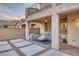 Inviting backyard with a covered patio, outdoor seating, and a modern fire pit at 12382 Piazzo St, Las Vegas, NV 89141