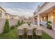 Inviting backyard with a dining table, manicured lawn, and a comfortable outdoor lounge area at 12382 Piazzo St, Las Vegas, NV 89141