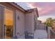 A private balcony with room for outdoor seating offers a relaxing space with neutral stucco finishes at 12382 Piazzo St, Las Vegas, NV 89141