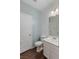 Clean bathroom featuring a toilet, vanity with sink, and a wood-look floor at 12382 Piazzo St, Las Vegas, NV 89141
