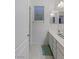 A well-lit bathroom with a single sink vanity, neutral tile floor, and a window with blinds, offering a clean and functional space at 12382 Piazzo St, Las Vegas, NV 89141