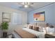 Serene bedroom featuring a neutral bed, contemporary art, bedside lamps, and a plant, creating a calming atmosphere at 12382 Piazzo St, Las Vegas, NV 89141