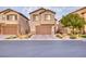 Charming home features a well-manicured lawn, a brick driveway, and an attached two-car garage at 12382 Piazzo St, Las Vegas, NV 89141