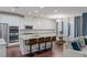 Open-concept kitchen with stainless steel appliances, large island, and adjacent dining area at 12382 Piazzo St, Las Vegas, NV 89141