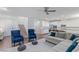 Inviting living room showcasing an open floor plan with kitchen view, cozy seating, and stairs at 12382 Piazzo St, Las Vegas, NV 89141