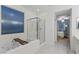 Modern bathroom featuring a soaking tub, walk-in shower, and view of main bedroom at 12382 Piazzo St, Las Vegas, NV 89141