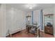Bright office with hardwood floors, a desk, a cushioned bench, and decorative shelving at 12382 Piazzo St, Las Vegas, NV 89141