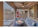 Covered patio with a stylish seating area and a modern fire pit at 12382 Piazzo St, Las Vegas, NV 89141