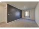 Spacious bedroom featuring a dark accent wall, neutral carpet, and a well-lit, open layout at 1631 Desert Path Ave, North Las Vegas, NV 89032