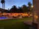 Backyard with a large pool, water features, built in BBQ, and lush landscaping at 1705 Pink Cliff Ct, Las Vegas, NV 89128