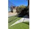 A backyard with a baseball cage that has turf, a batting cage and netting at 1705 Pink Cliff Ct, Las Vegas, NV 89128